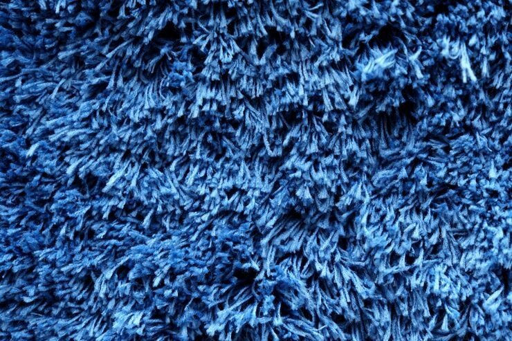 fuzzy-blue-plaid-shaggy-blanket-background-fluffy-fake-textile-fur-selective-focus_955139-7365